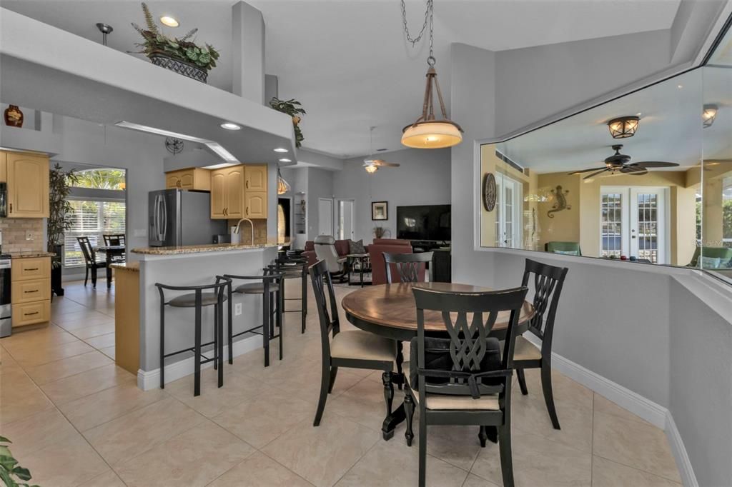 Dinette with aquarium window and large kitchen with breakfast bar.