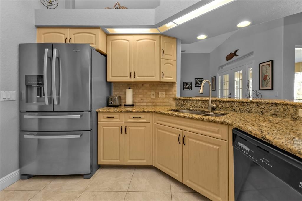 Beautiful kitchen space looking out into the family room, dinette area.