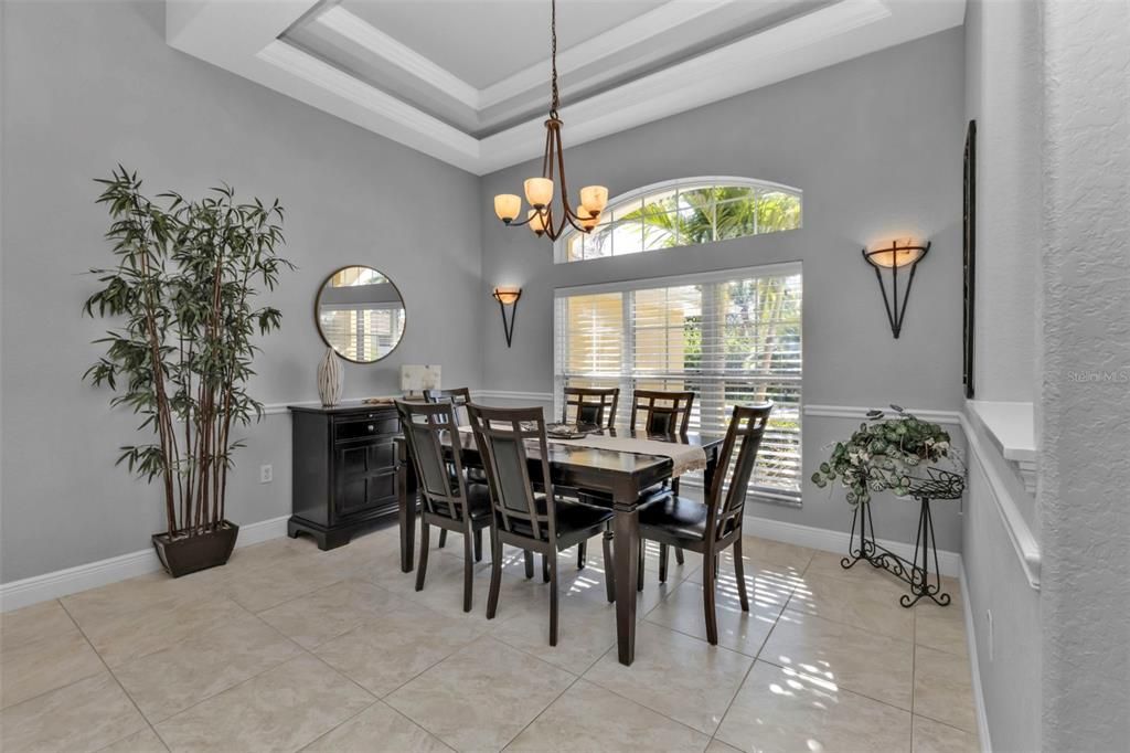 Large Dining room with coffered ceiling, chair rail, large windows and a transom window above for even more light!