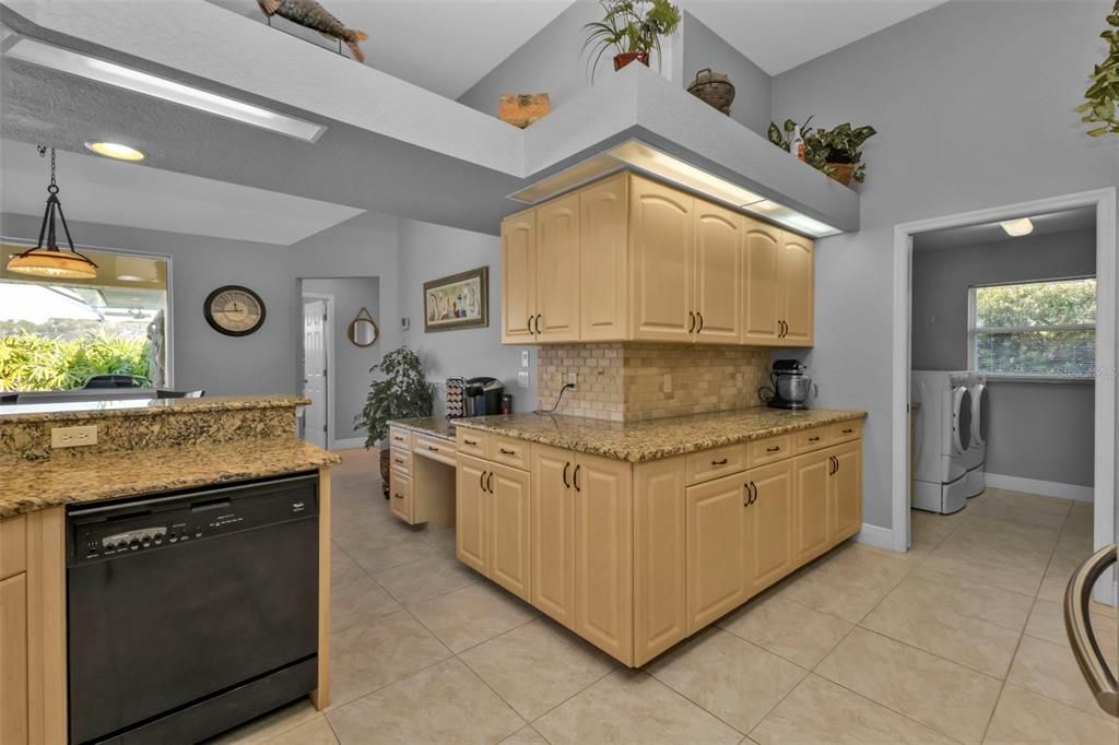 Cabinets go on and on! Kitchen leads into indoor laundry room.