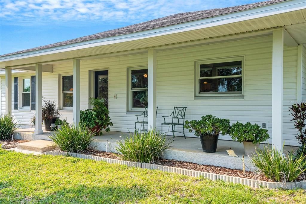 where the wide deep front porch beckons you to sit and relax.