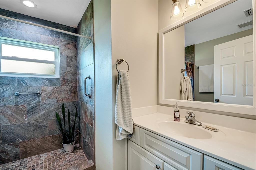 Bathroom #2 now boasts and fully tile easy access walk-in shower and new vanity, lighting, and plumbing fixtures.