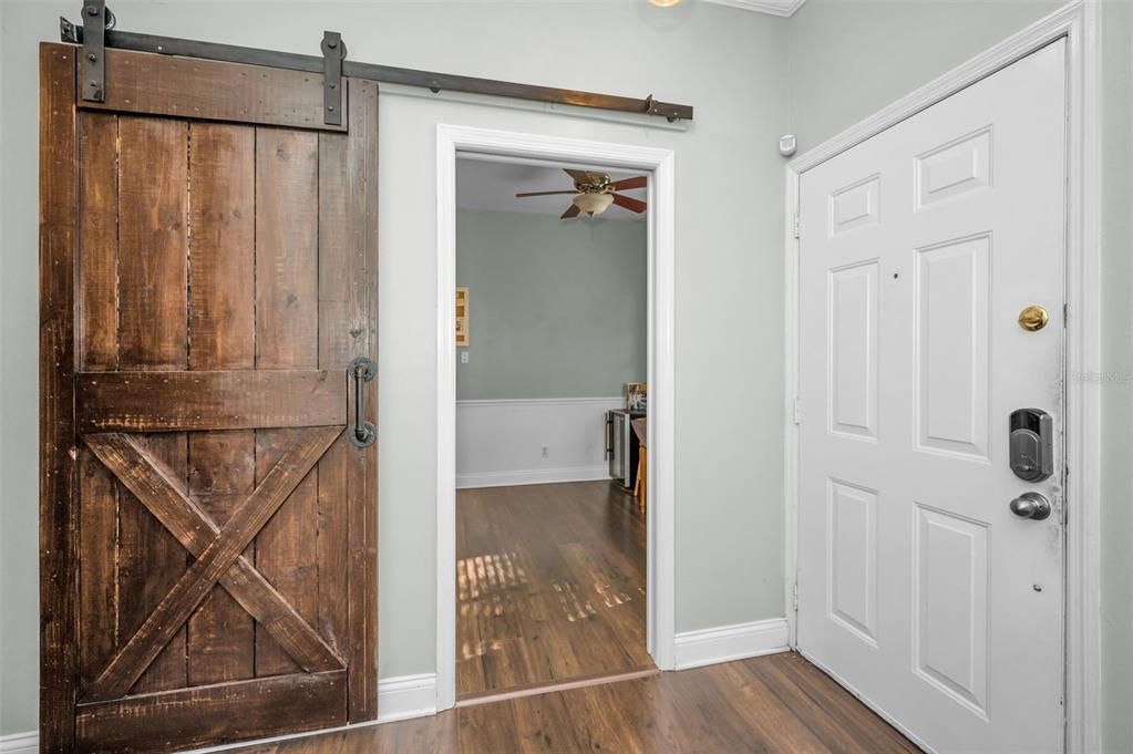 CUSTOM SLIDING BARN DOOR LEADING TO THE LARGE EAT IN KITCHEN