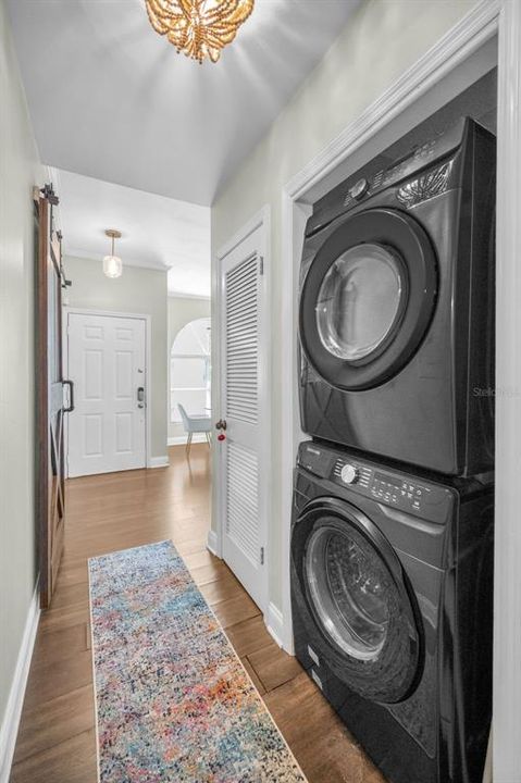 Laundry closet with washer and dryer located in bedrooms hallway