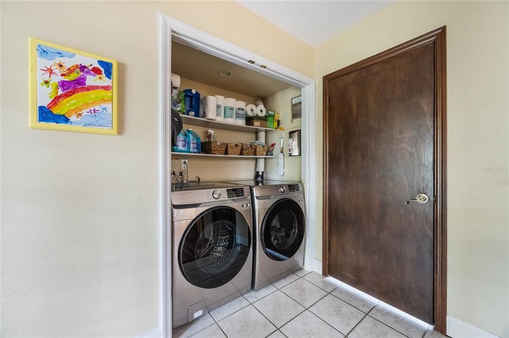 This photo features the laundry close on the left, to the right is and to the right is the door that leads to the 4th bedroom.