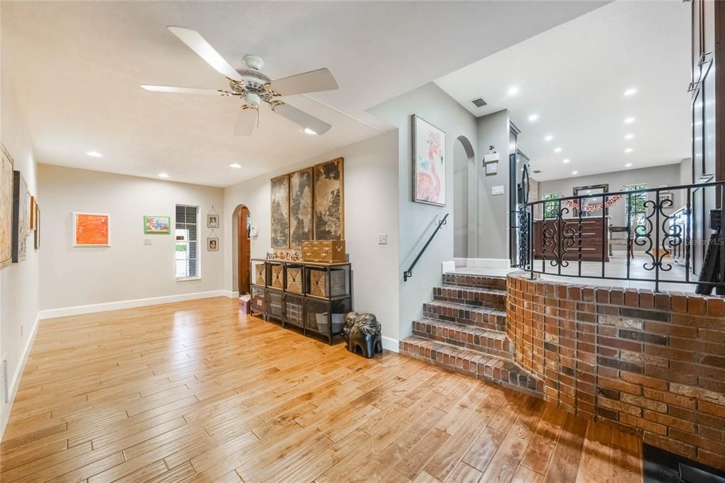 This is the view of part of the L-shaped bonus room with a few stairs to the right leading to the family room.