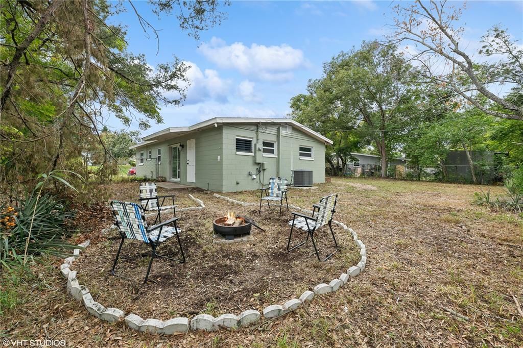 fenced in backyard with firepit