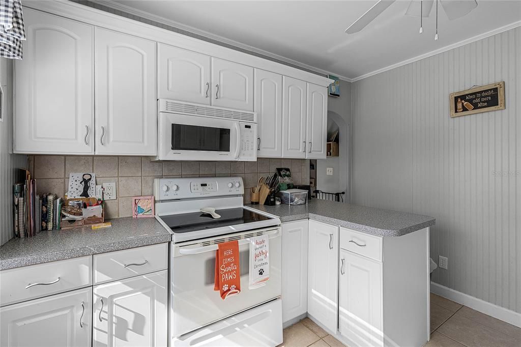 Tile backsplash in kitchen with beadboard walls