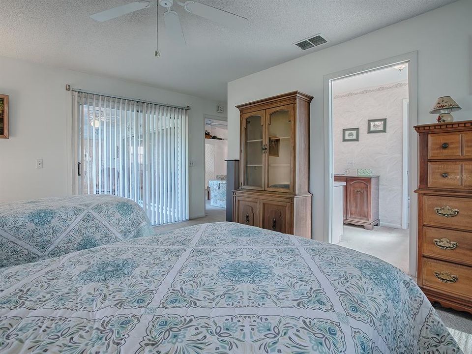 GLASS SLIDERS LEAD FROM THE MASTER BEDROOM TO THE LANAI