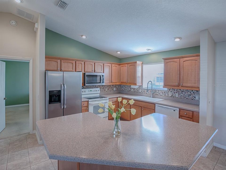 LOOK OVER THE BREAKFAST BAR INTO THIS UPDATED KITCHEN...