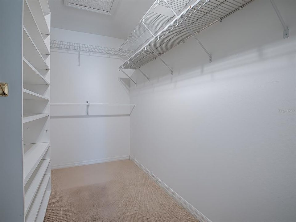 HUGE WALK-IN CLOSET HAS BUILT IN SHELVING AND PLENTY OF SPACE FOR SO MUCH