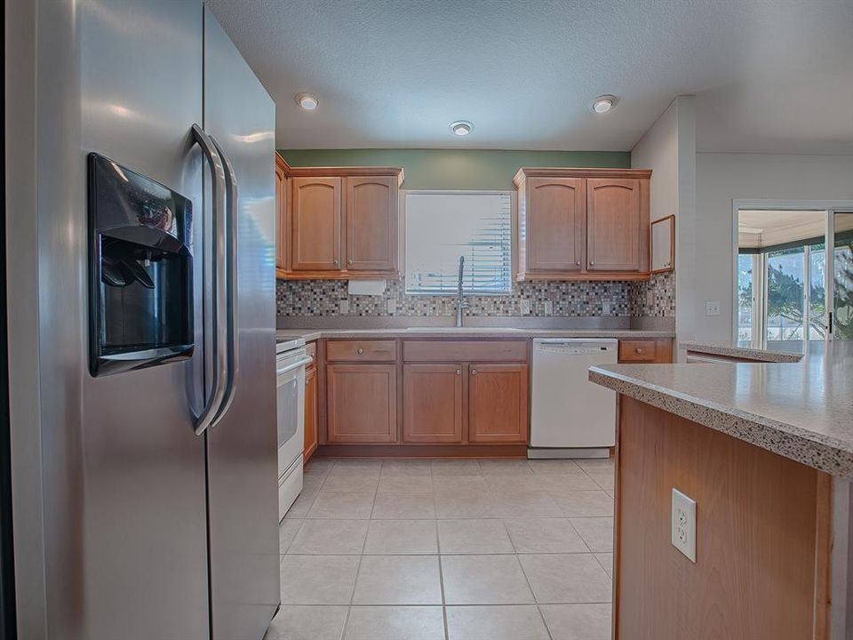 STAINLESS REFRIGERATOR AND PLENTY OF CABINETS