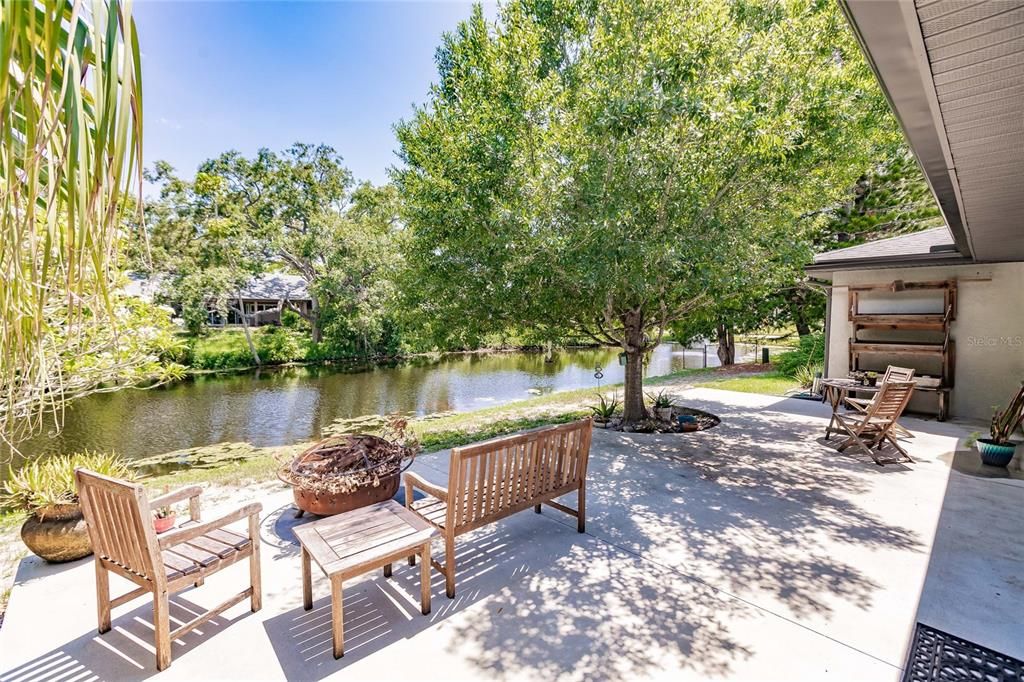 Large Cement Patio with Canal Behind Home