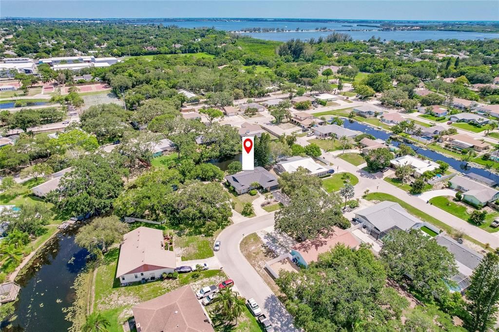 AERIAL VIEW WITH CANAL BEHIND HOME W/SARASOTA BAY IN THE DISTANCE