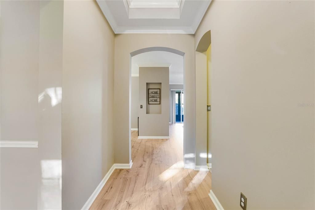 5'6" x 11' Foyer w/ laminate flooring, tray ceiling & crown molding