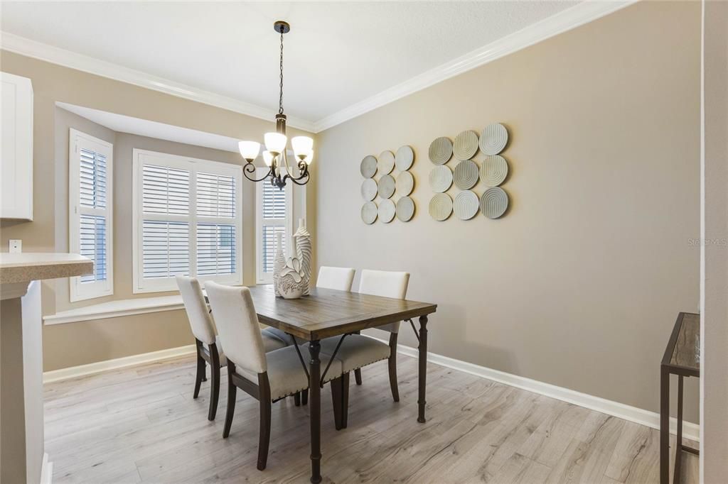 15' x 9' Dinette area w/ crown molding, Plantation style shutters & a bench seat