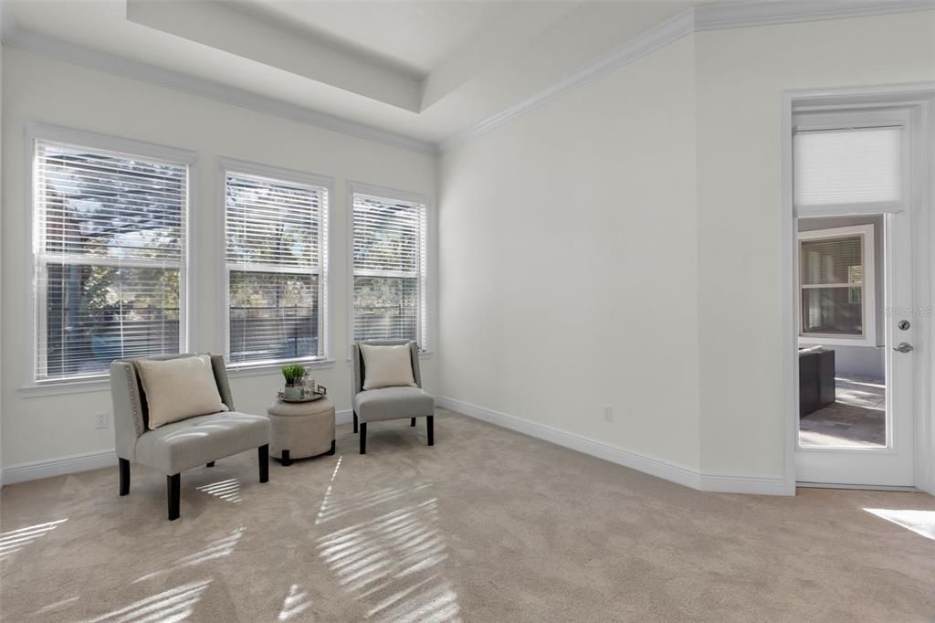 Primary Bedroom- Spacious sitting area overlooking the pool.