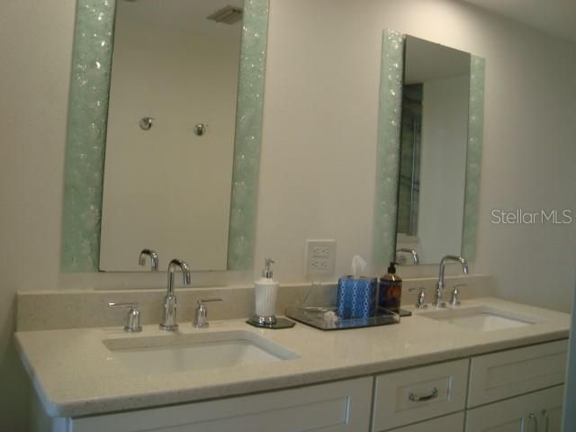 A DOUBLE VANITY AND A WALK IN SHOWER THAT HAS BEEN REMODELED