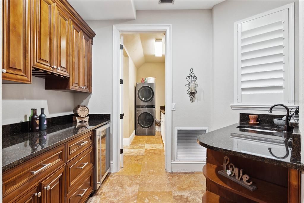 Wet bar,  wine refrigerator and plenty of storage adjacent to the family room. Perfect for entertaining!