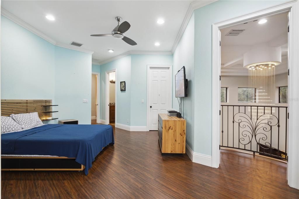 Bedroom #4 with a Juliet balcony overlooking the family room and an exterior balcony overlooking the pool/lake