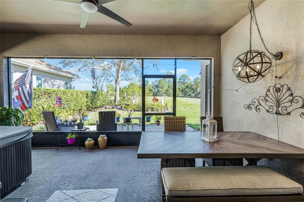 Generous screened lanai with spa, ceiling fan and ample table area