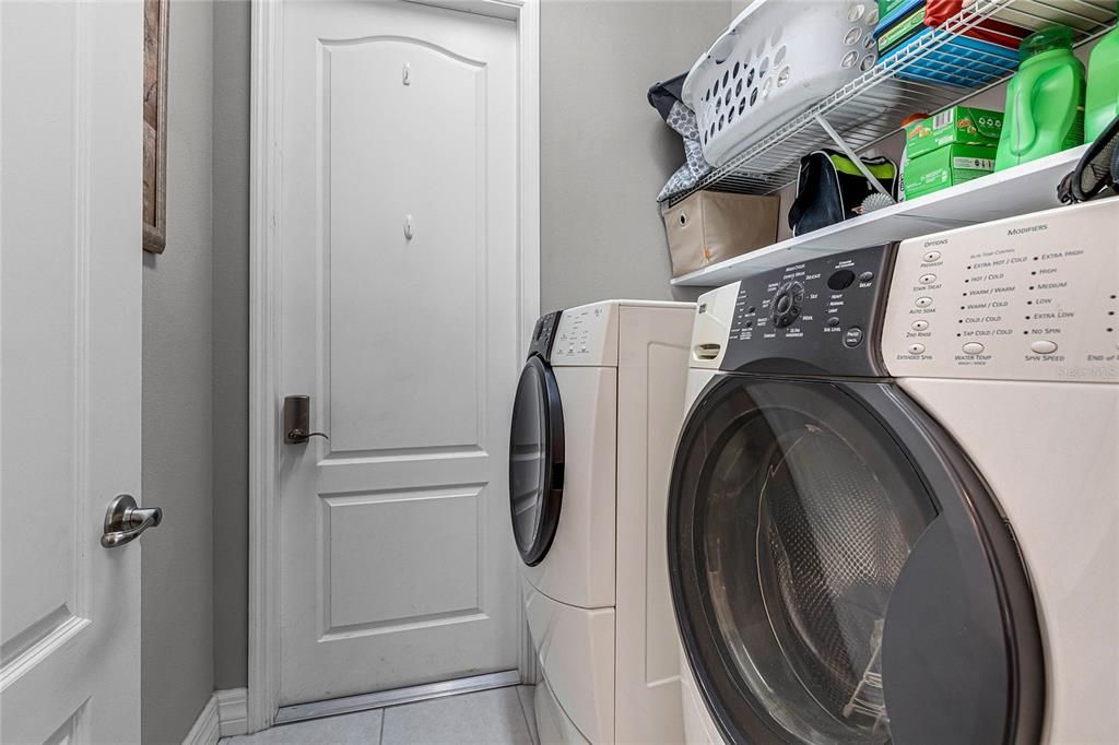 Pass-through laundry between garage and kitchen space