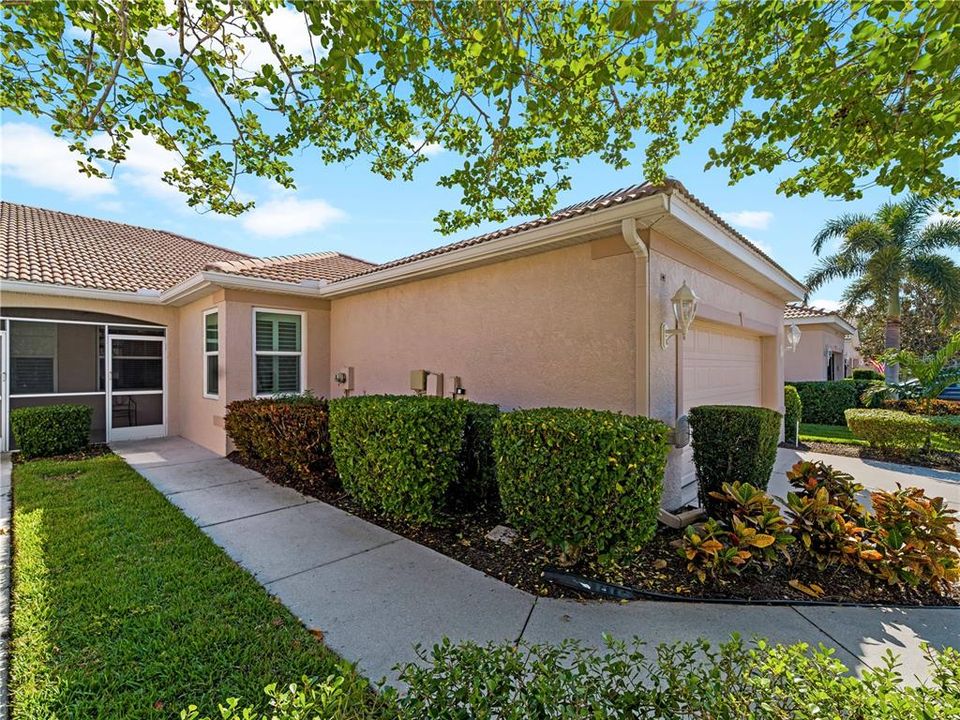 Pathway to the front screened Entranceway where this home packs so much into its 1,576 sq.ft.