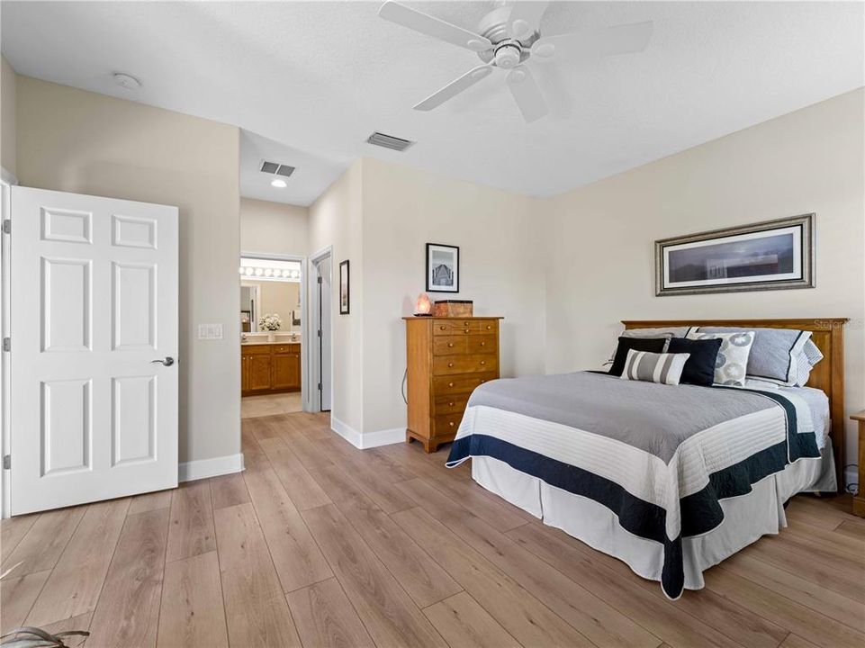 Spacious En-Suite Primary Bedroom with Walk-in Custom Built-in feature Closet and secondary closet also with built-in features.