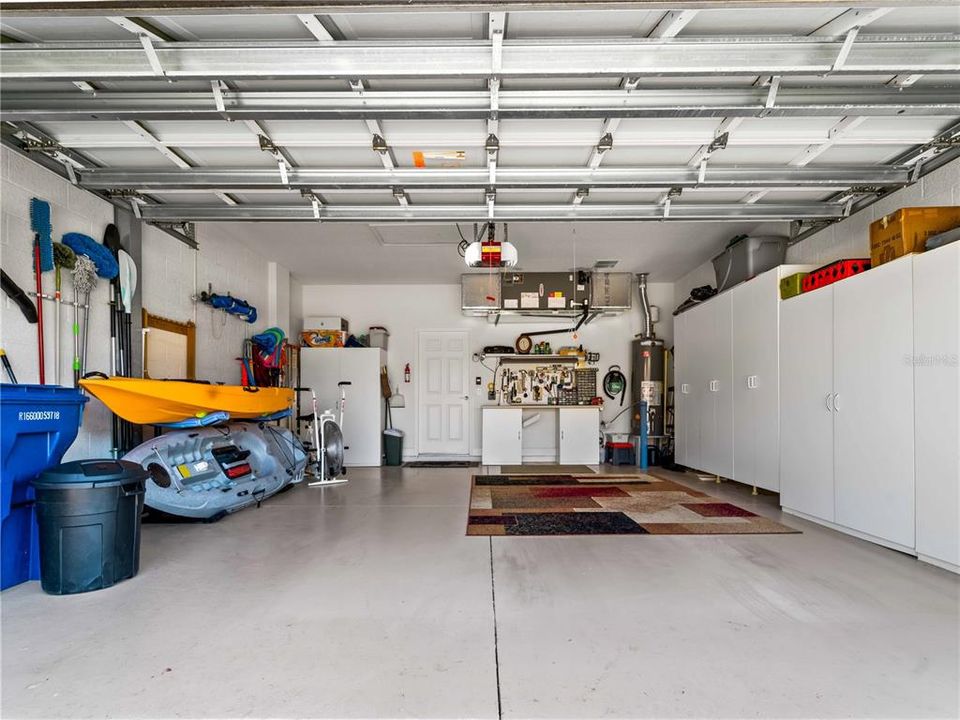 Two Car Garage with Work Bench and wall to wall  Storage Cabinets.