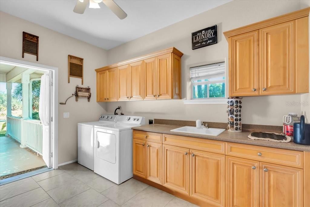 Laundry Room with side yard access to the gazebo, detached single-car garage and chicken coop of Main Residence at Tall Palms Ranch