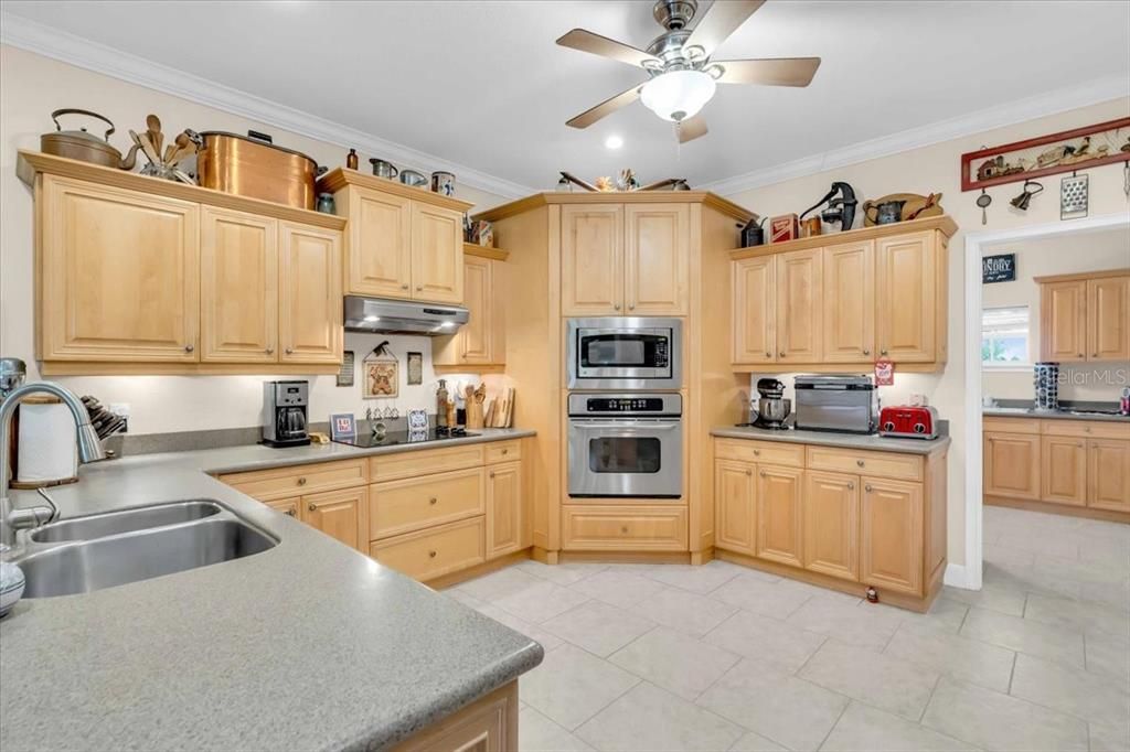 Kitchen with Laundry Room Access and Game Room Hallway of Main Residence at Tall Palms Ranch