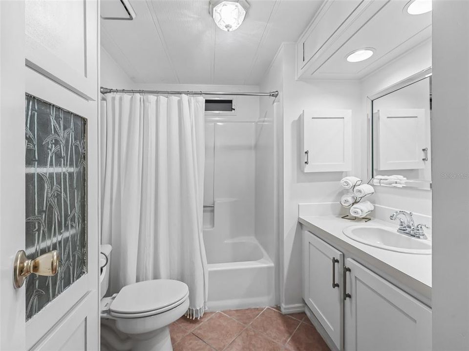 Guest bathroom with extra storage tub/shower combo