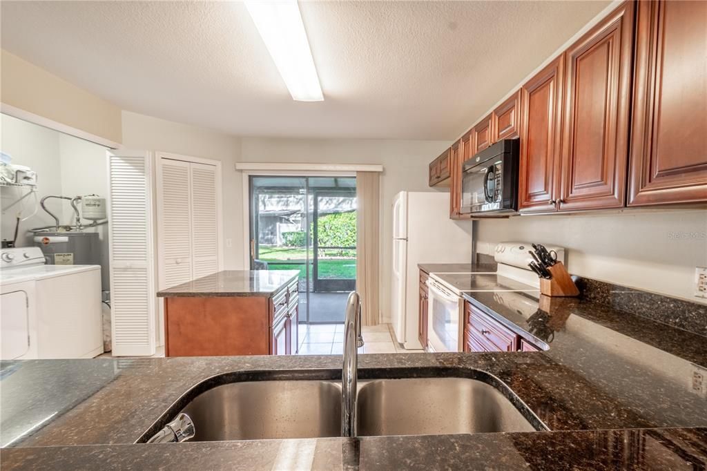 The kitchen features a double basin stainless steel sink and closet pantry.