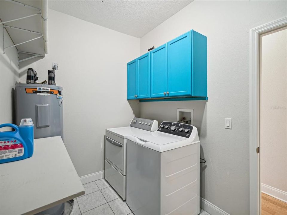 Laundry / Utility room with built in cabinets and shelving