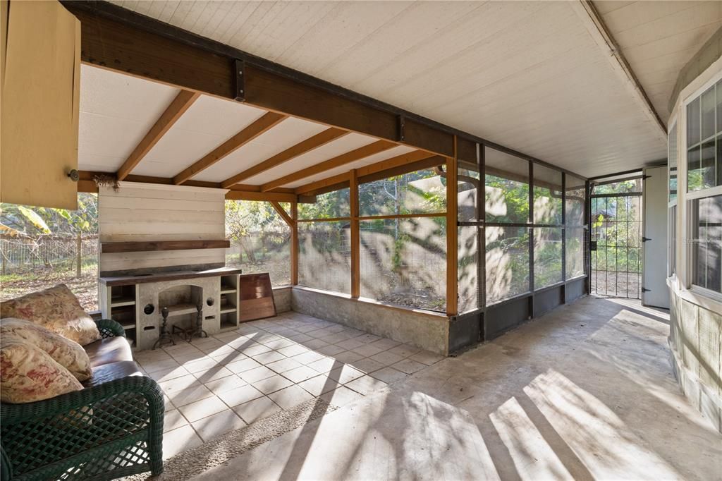 Front enclosed, screen porch with rocket stove