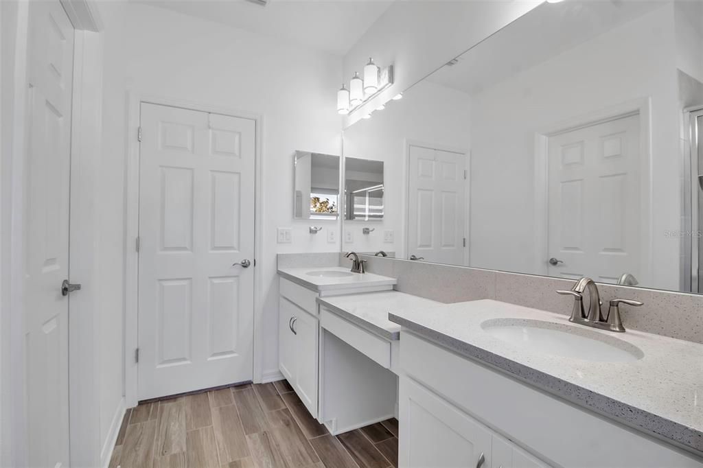 Primary bath with double vanities and makeup shelf