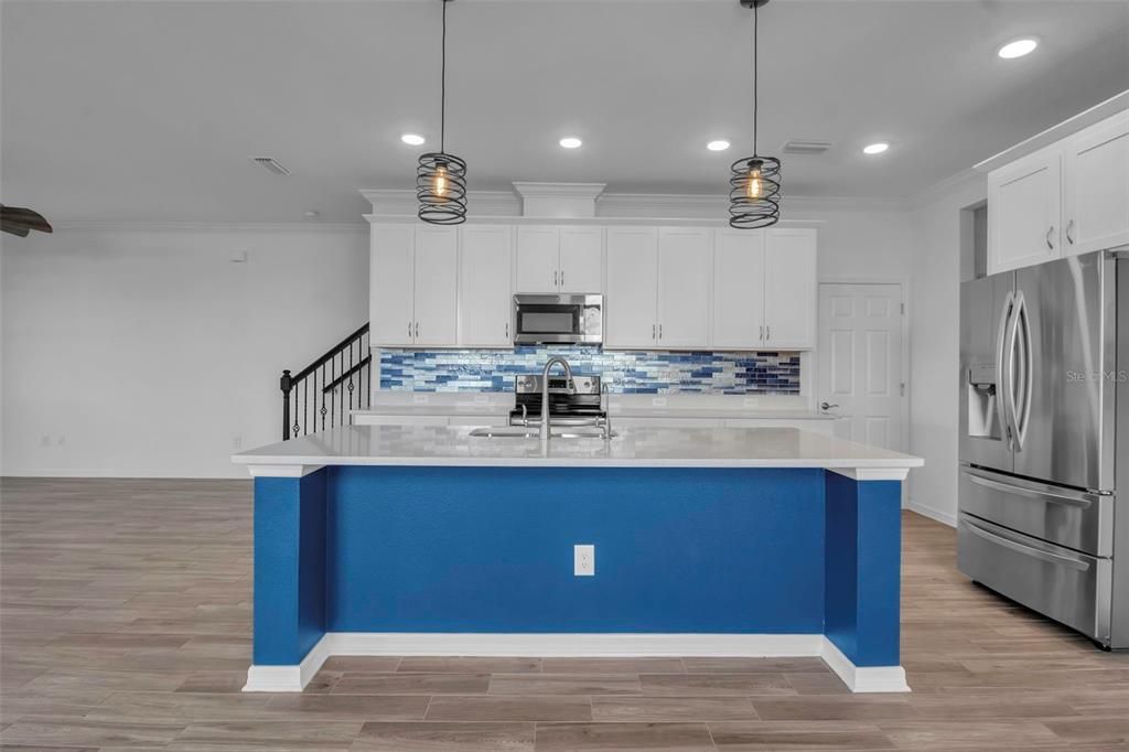 The door next to the back cabinets? You'll fall in love with the pantry!