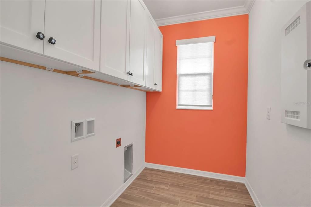 Large Laundry room is off the kitchen- You'll appreciate the upper cabinets