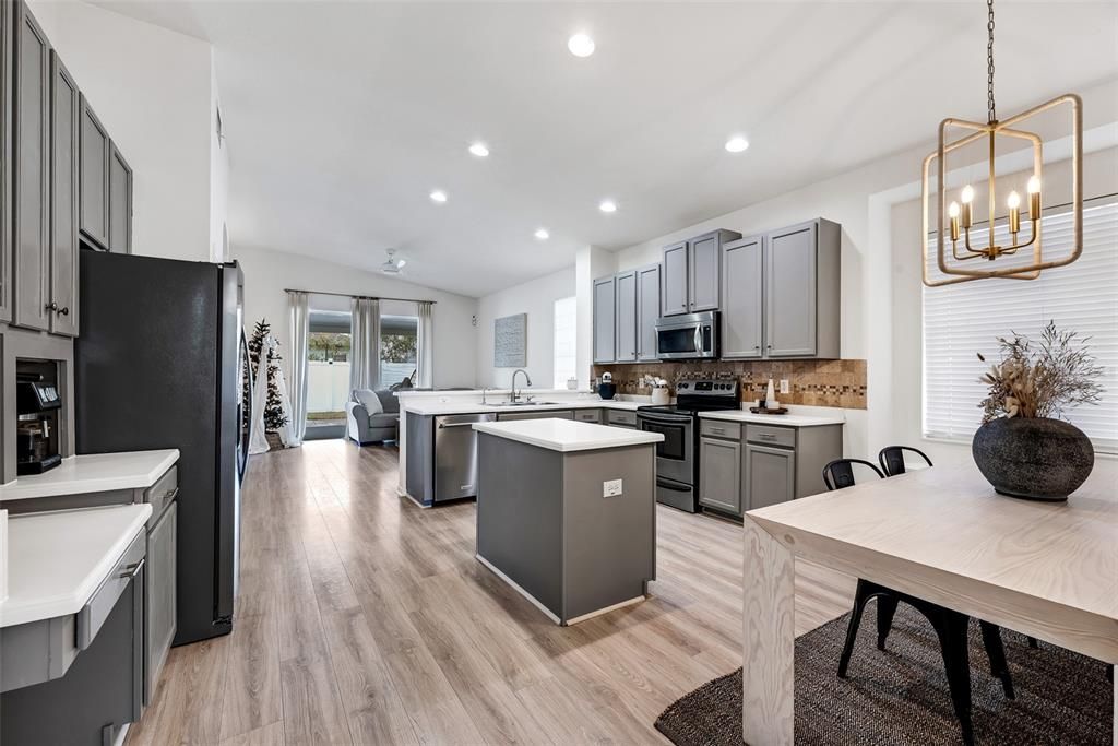 The updated kitchen is a true highlight, featuring sleek stainless steel appliances, breakfast bar, island, spacious closet pantry, and eat-in area.