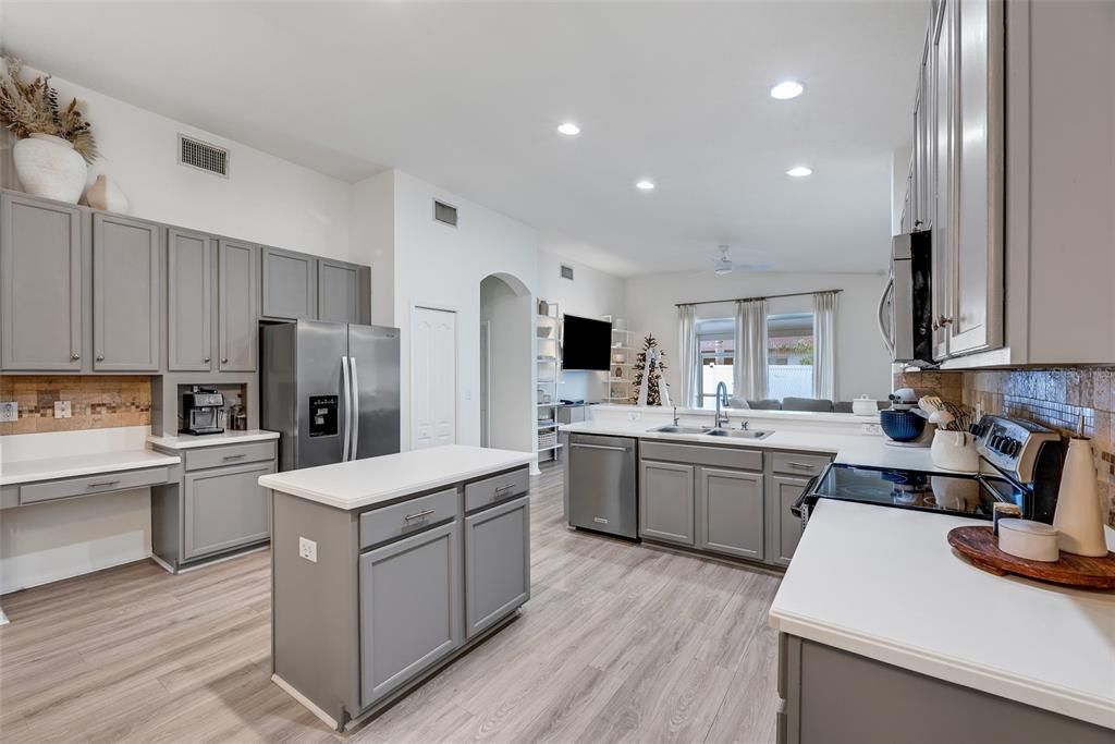 A large bank of cabinets opposite the range and a built-in desk make the perfect coffee station.