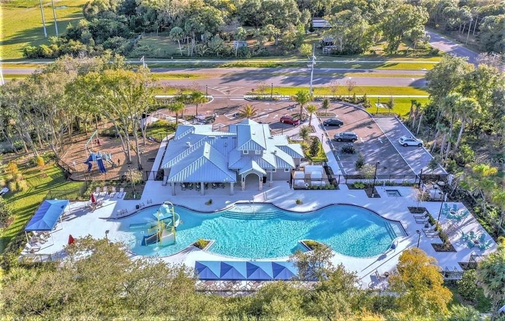 Aerial view of the Sanctuary which offers a larger pool with a water slide, fitness center, community club room with a catering kitchen, basketball court, park and playground.