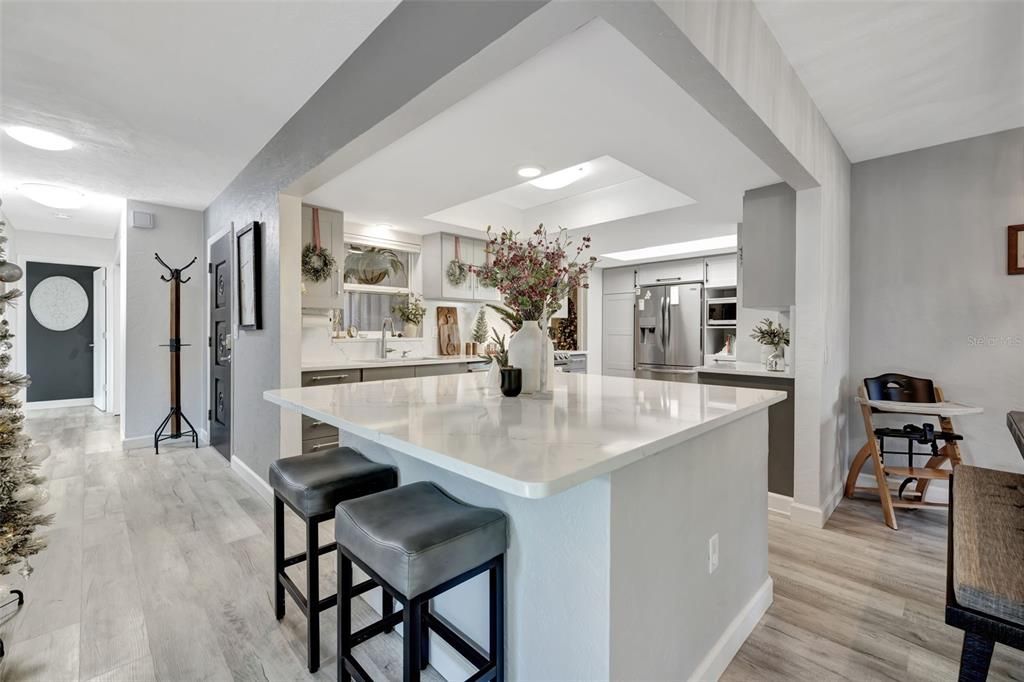 Kitchen with entry/foyer to the left and ding to the right