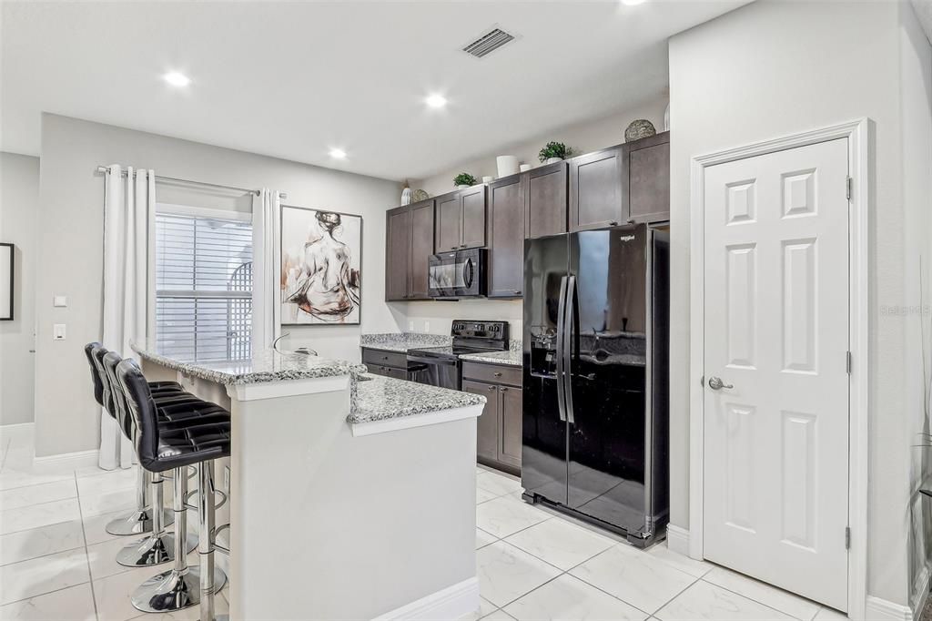 The kitchen, dining and living areas are all open to each other making gathering with family or entertaining friends a breeze - your kitchen delivers rich cabinetry that perfectly compliments the granite counters and the living area features a stylish tray ceiling and sliding glass door access to the SCREENED LANAI.