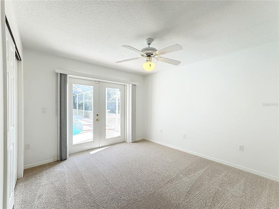 Bedroom 3 with French doors leading to the pool