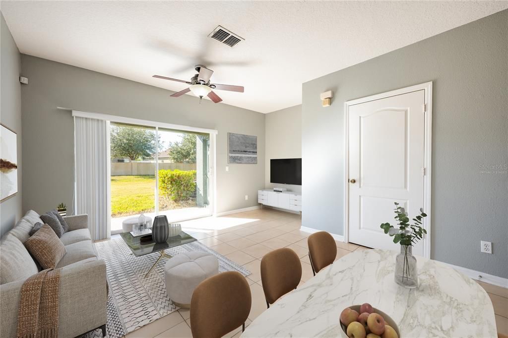 The living and dining room combo provides an open feel with high ceilings and SLIDING GLASS DOORS that open up to a large COVERED LANAI complete with additional storage space. Virtually Staged.