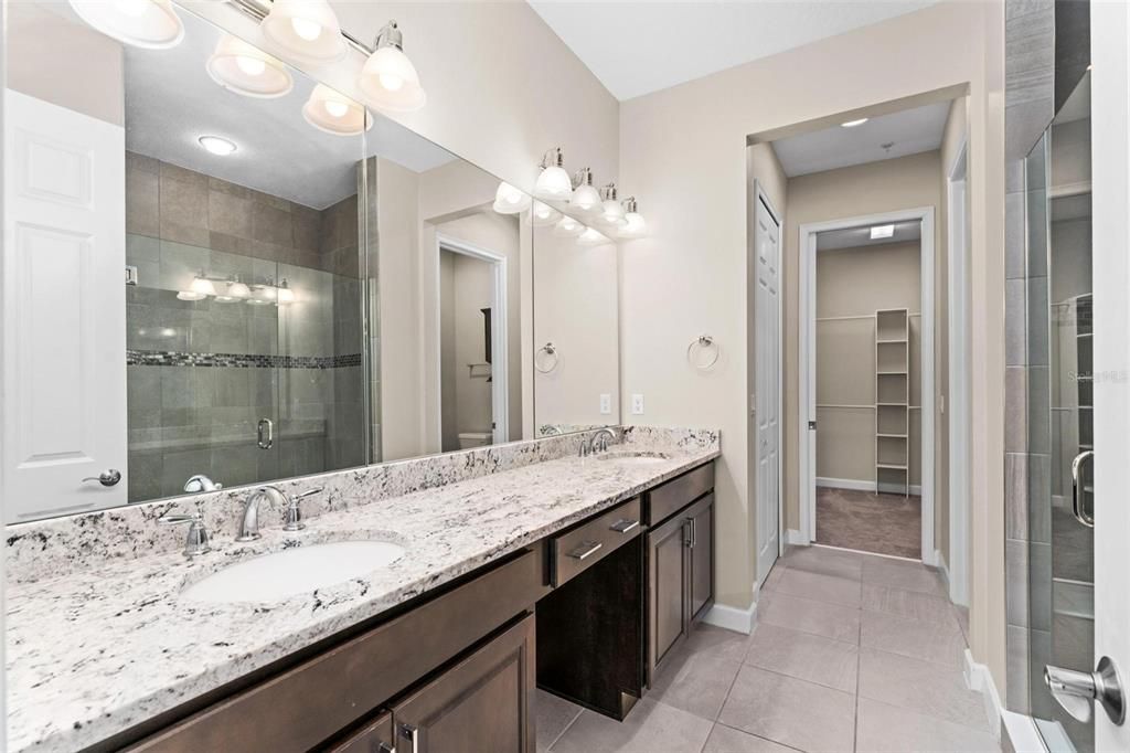 Primary en-suite features beautiful granite counters, under mount dual sinks and beautiful Espresso cabinets.