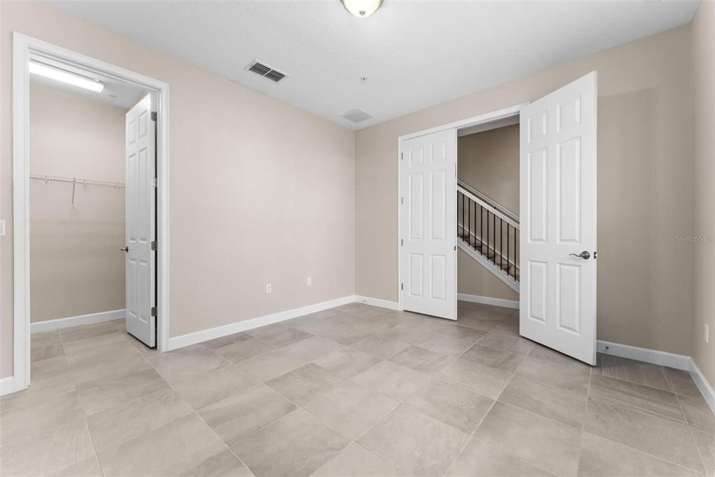 Oversized downstairs bedroom with double door entry.