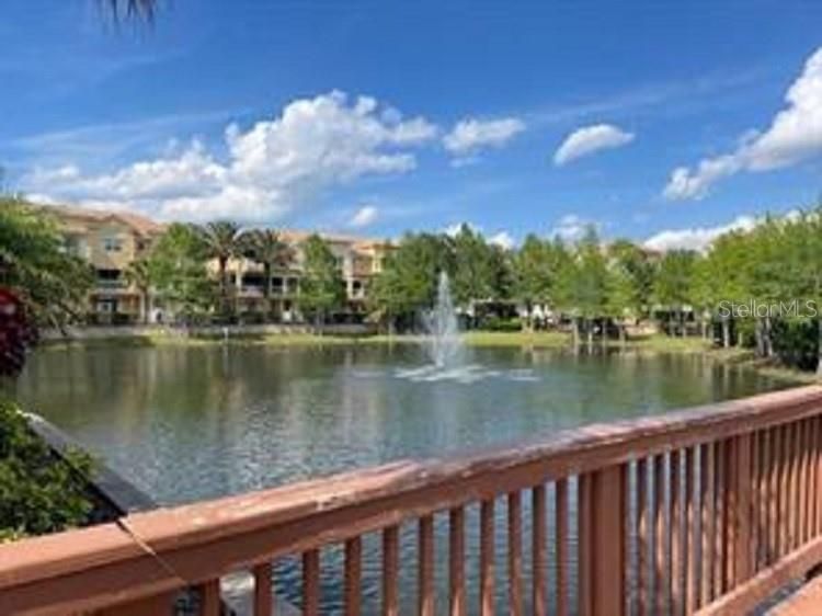 Fountains on both sides of the wooden walkway.