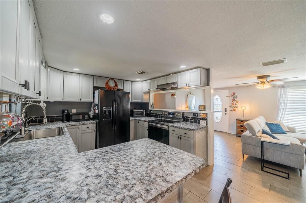 WELL LIT KITCHEN AREA WITH ALL APPLIANCES INCLUDED