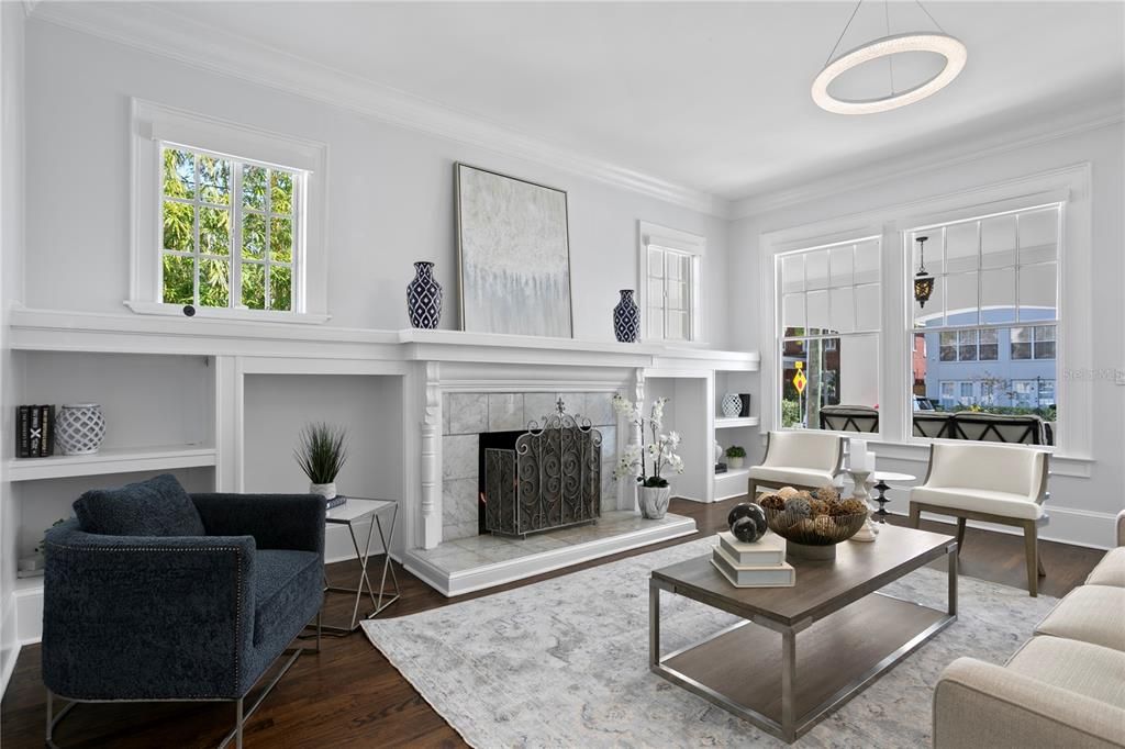 Step inside the home into the formal living room with fireplace with marble surround, flanked by built ins and loads of windows allowing beautiful natural light to fill the space.